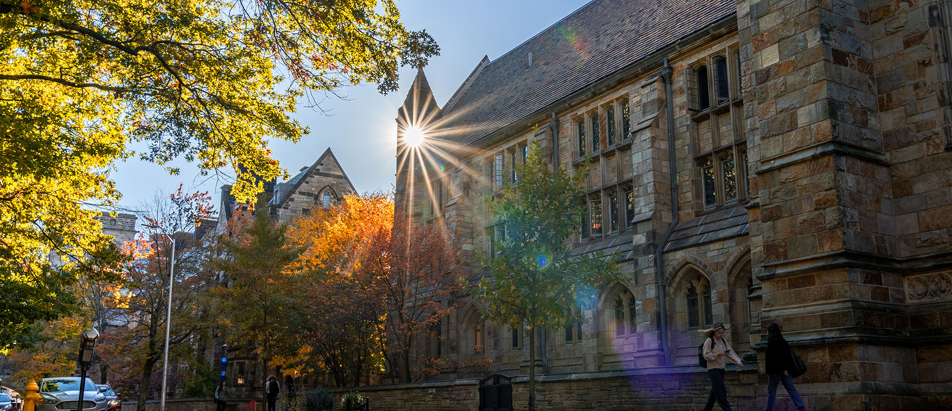 Sunlight shining around the side of a stone building