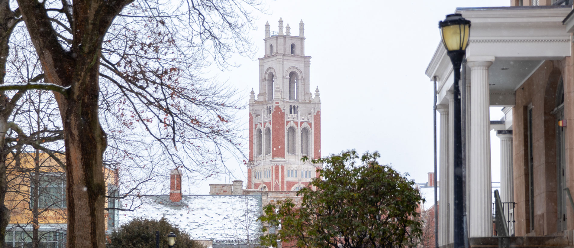 Yale clock tower in the background of snowy field