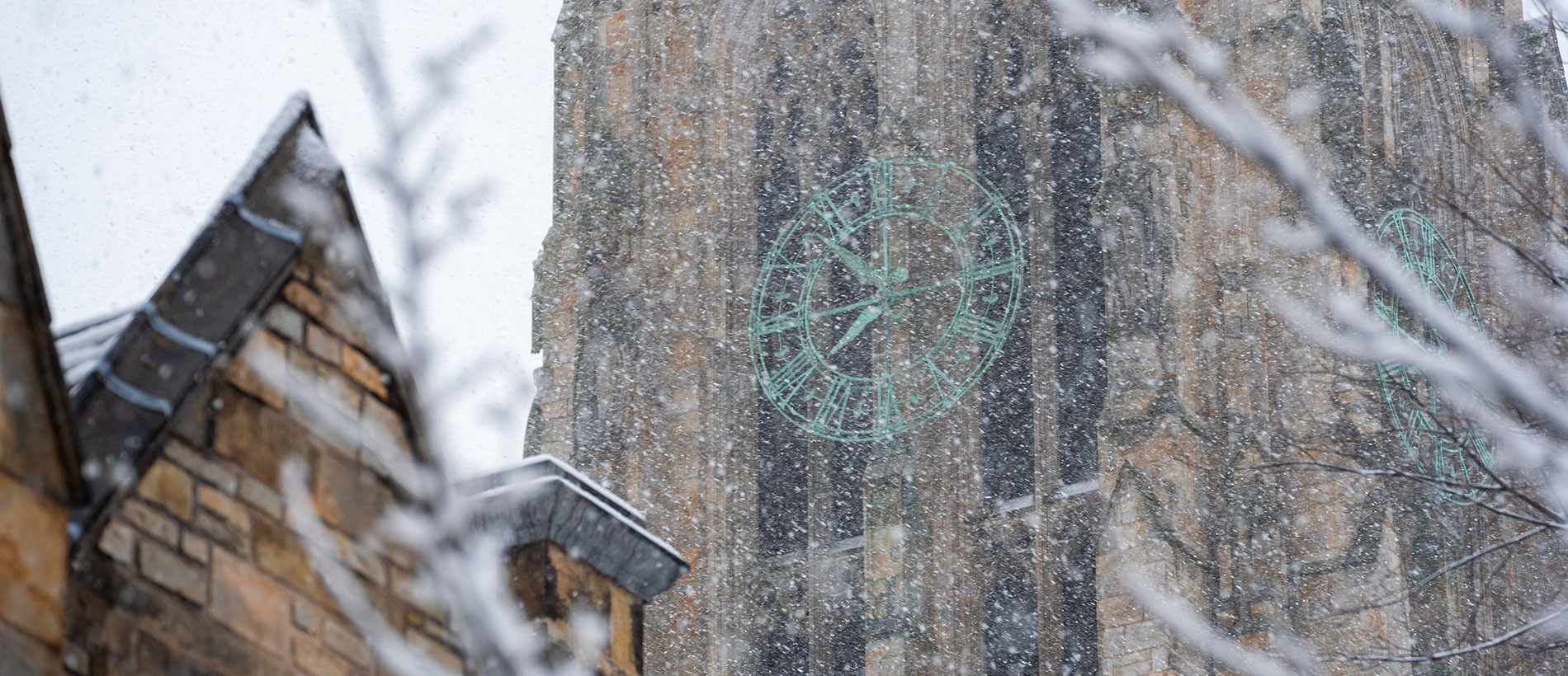 Gentle snow fall with Yale clock behind