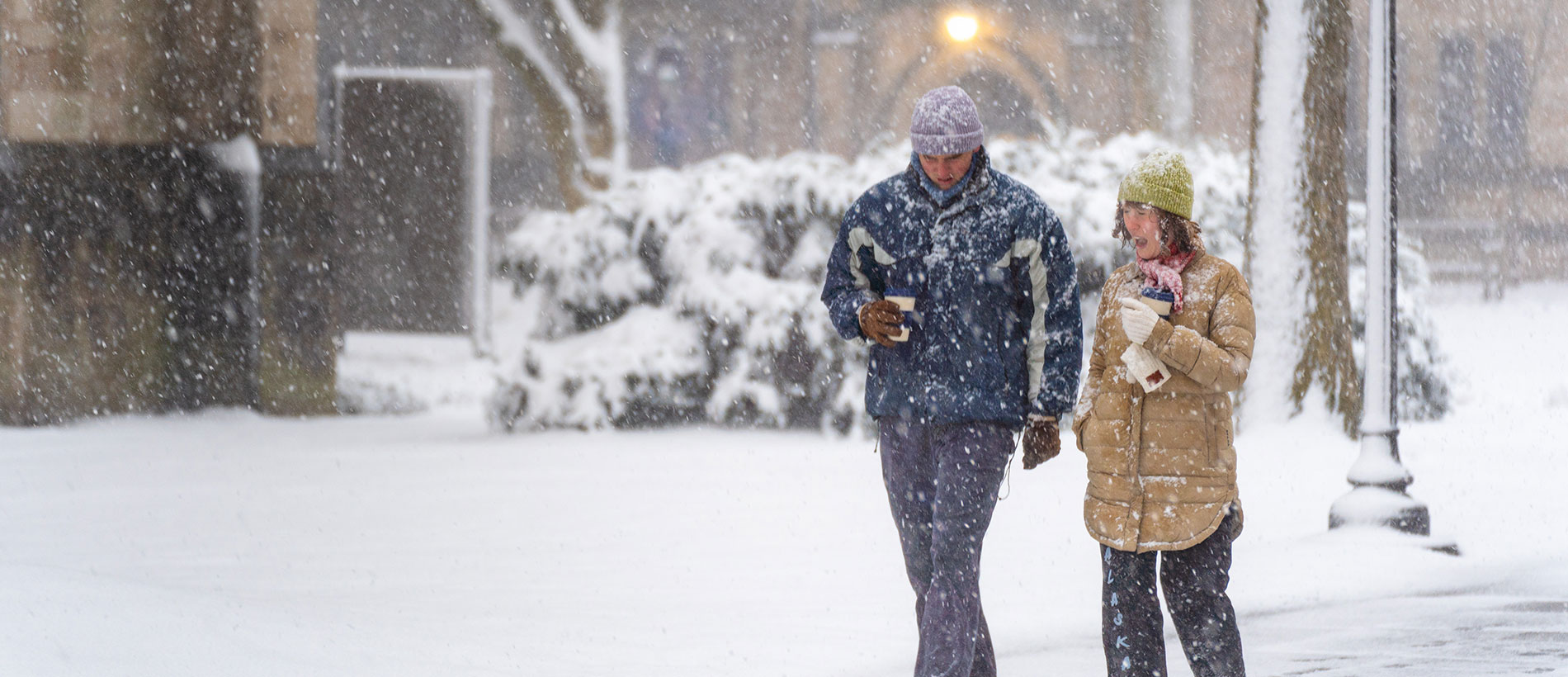 Yale students bundled up and walking through the snow