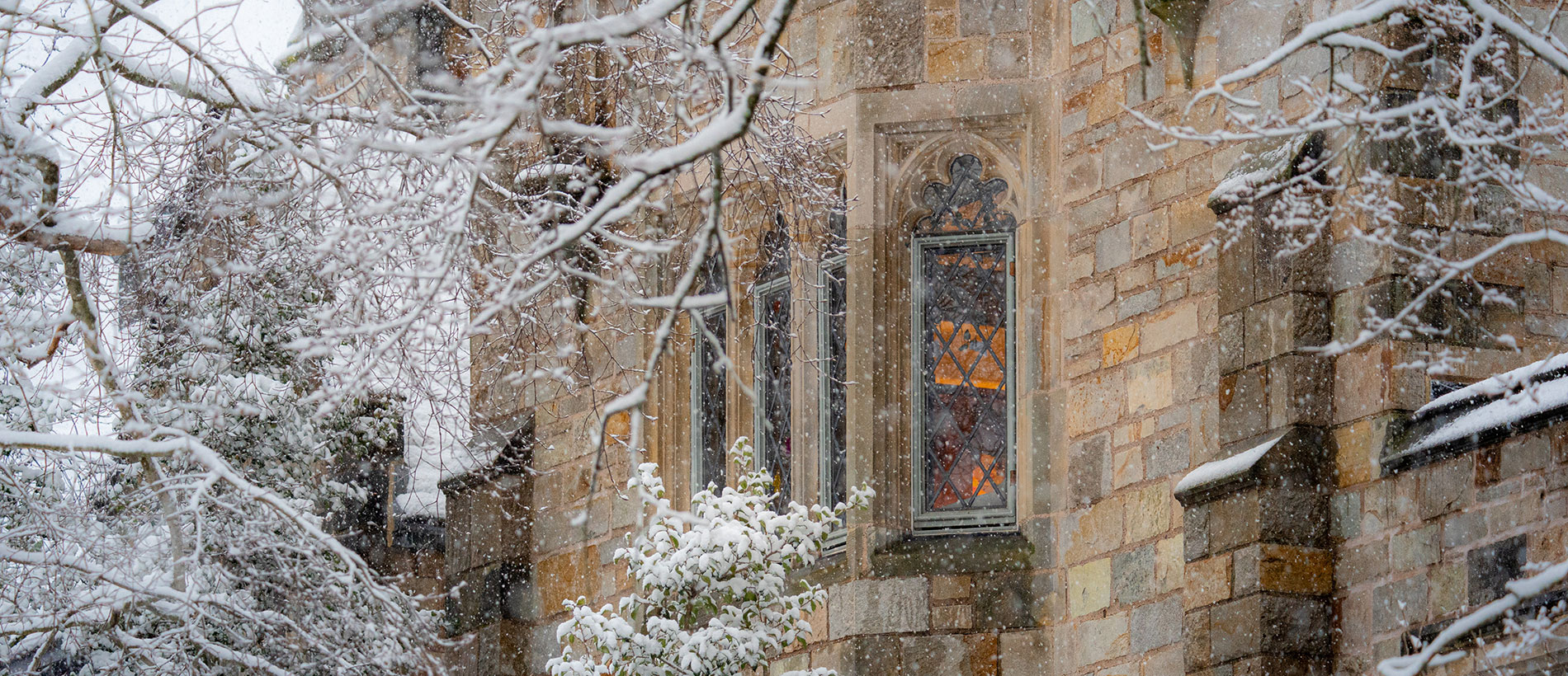 Warm light shining through a window onto a snowy landscape