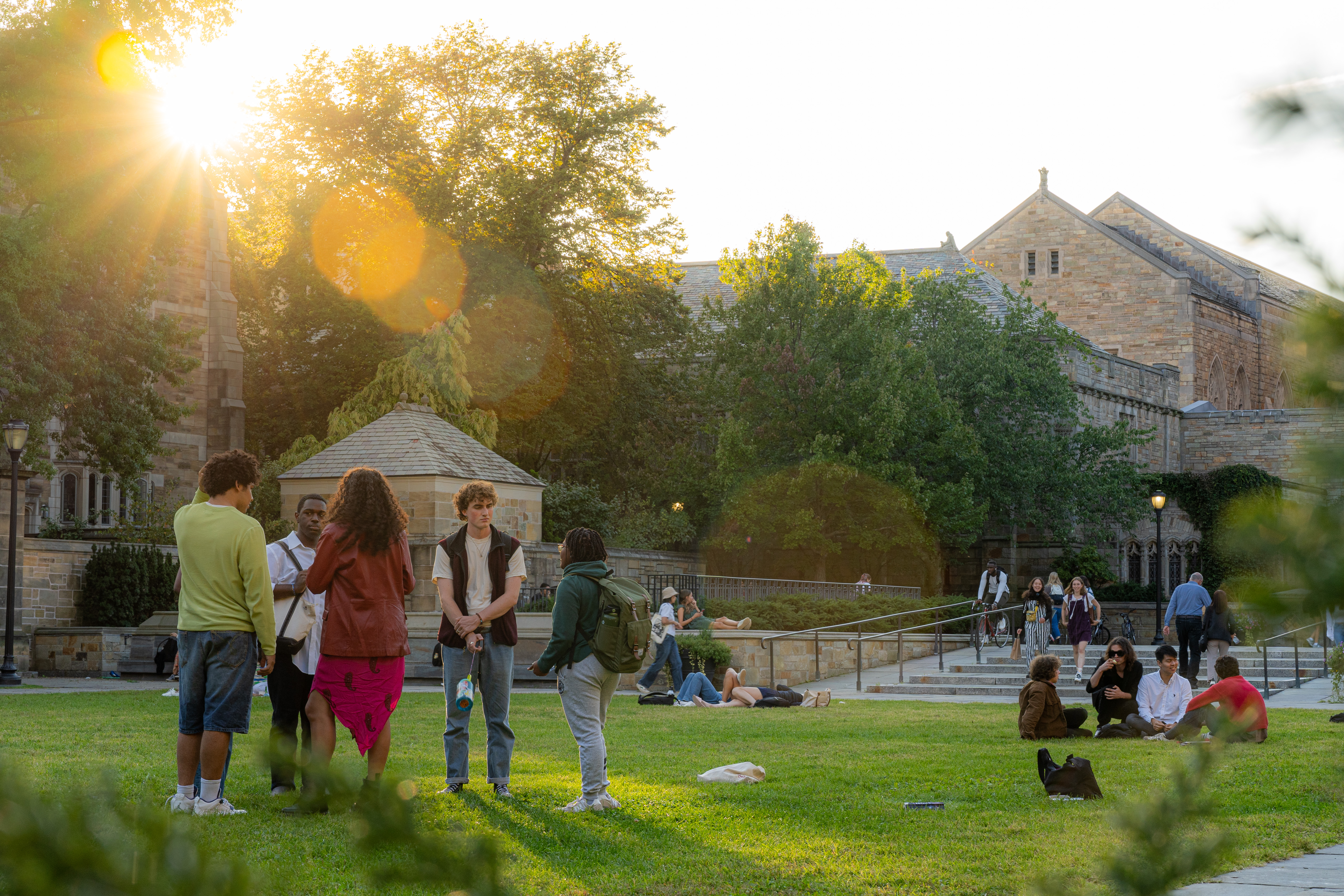 sun shining around stone building on Yale campus