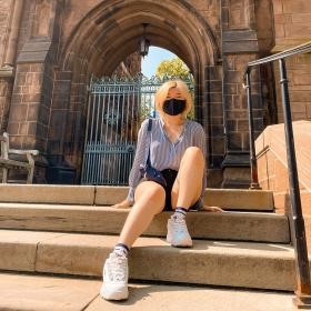 Philomena sitting on the steps at Yale